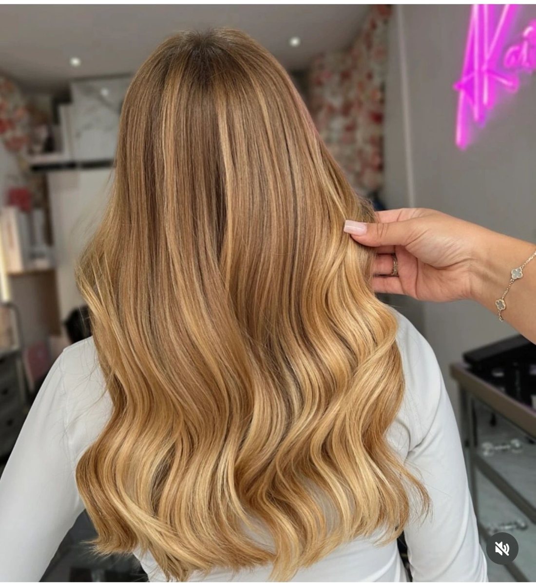 Honey balayage at AKAI under the pink neon sign